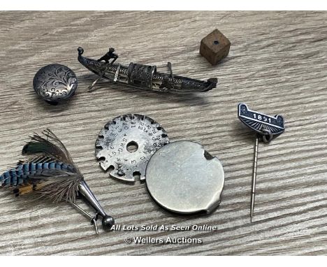 SIX VINTAGE OBJECTS SILVER BUTTON, WIRE GAUGE, 1891 PIN, FEATHERED BROOCH, SMALL METAL GONDOLA AND TINY WOODEN DICE 