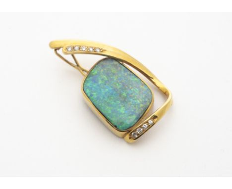 A continental black opal and diamond yellow metal pendant, marked 750, the large opal in a rubbed over setting with a bifurca