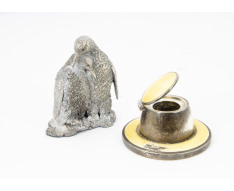 An Art Deco silver and yellow enamel capstan inkwell, AF, together with a modern silver filled group of two cuddling penguins