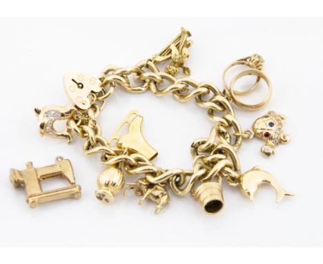 A 9ct gold curb link bracelet, with multiple charms and a padlock clasp including an elephant, gem set tortoise, various wedd