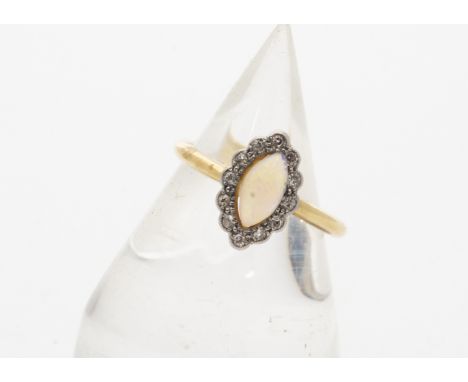 An Edwardian opal and diamond navette shaped ring, the oval cabochon opal surrounded by a bezel of old cut diamonds, ring siz