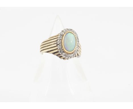 A 14k continental opal and diamond dress ring, the white opal cabochon in gold collet setting surrounded by a bezel of eight 