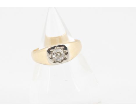 An Art Deco 18ct gold diamond set signet ring, the old cut diamond in gypsy white metal setting, with yellow gold shoulders a