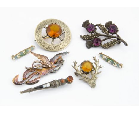 A Scottish silver hardstone dirk brooch, together with two white metal and citrine paste set Scottish brooches, a miracle pas