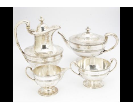 A George V silver four piece Scottish silver tea set by JF, Glasgow 1927, comprising teapot, hot water jug, sugar basin and m