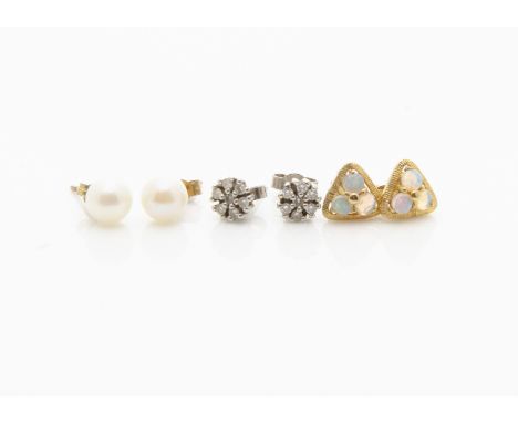 A pair of diamond cluster studs, a pair of white precious opal studs and a pair of cultured pearl ear studs (6) 