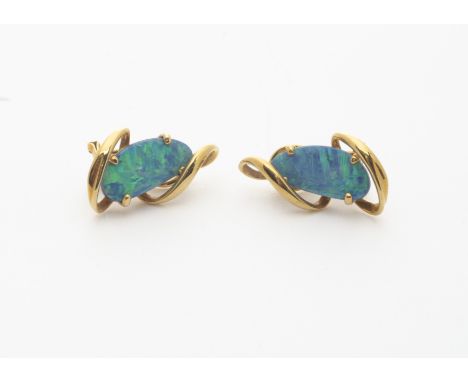 A pair of 18ct gold and opal doublet clip earrings, the black opal panels in claw setting surrounded by a scroll design, mark