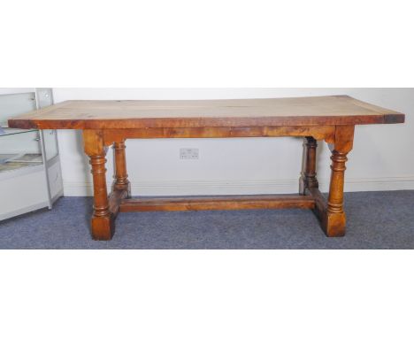 A good refectory table: finely figured and patinated thick two-plank walnut top with cleated ends; four oak gun-barrel-style 