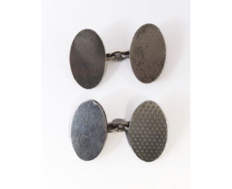 A pair of gentleman's heavy, hallmarked-silver cufflinks of oval form: one side unengraved, the other with engine turning