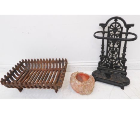 A small late 19th century cast-iron stick-stand, an iron fire-grate and a hand-hewn rock / stone bowl (3)