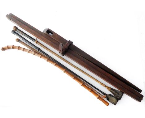 A wooden measuring stick, two riding crops and a bamboo show cane