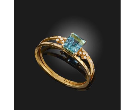 An aquamarine and diamond bangle, set with a large step-cut aquamarine within diamond borders in yellow gold, hinged opening 