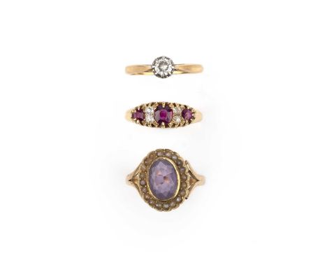 A group of three rings, including, a ring set with three cushion-shaped rubies, spaced by pairs of cushion-shaped diamonds, m