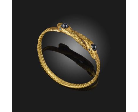A sapphire-set gold serpent bangle, each snake set with sapphire cabochon eyes and a sugarloaf sapphire to its head in yellow