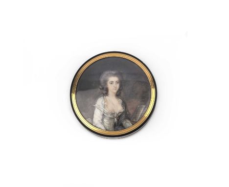 λ A portrait miniature box, late 18th century, of circular outline in tortoiseshell, the top and base each set with a painted