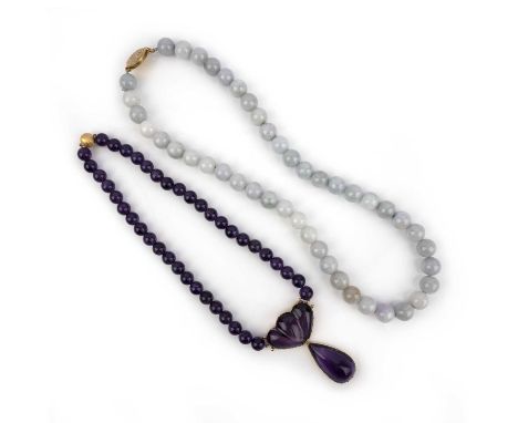 Two necklaces, one composed of pale green and lavender jadeite beads, to a gold clasp, length 61cm; and a necklace set with p