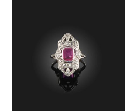 A synthetic ruby and diamond ring, early 20th century, set with a step-cut synthetic ruby, within a shield-shaped mount set w