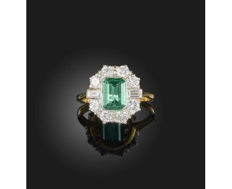 An emerald and diamond ring, set with a step-cut emerald weighing 1.20 carats, within a border of brilliant-cut and baguette 