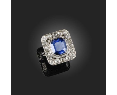 A sapphire and diamond ring, early 20th century composite, of rectangular outline, centring on a collet-set step-cut sapphire