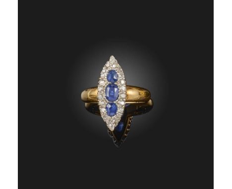 A late 19th century sapphire and diamond ring, of lozenge design, set with three graduated oval-shaped sapphires within a bor