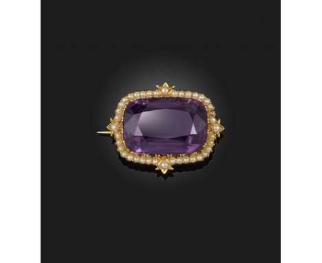 A Victorian amethyst and seed pearl brooch, late 19th century, set with an elongated cushion-shaped amethyst, within a border
