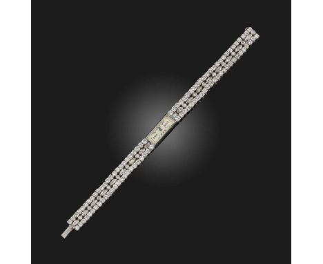 Cartier, a diamond wristwatch, mid 20th century composite, the narrow rectangular dial applied with white enamel, with black 