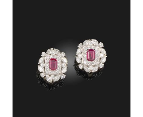 A pair of ruby and diamond ear clips, each of cluster design, set with a step-cut ruby within a border of brilliant-cut and m