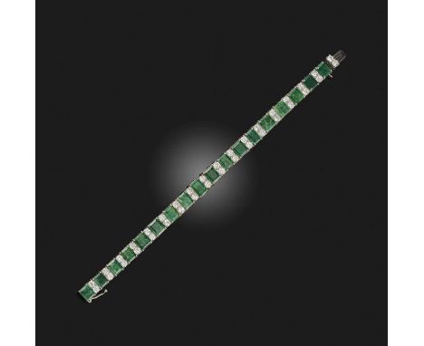 An emerald and diamond bracelet, set with graduated step-cut emeralds, spaced by pairs of brilliant-cut diamonds, mounted in 