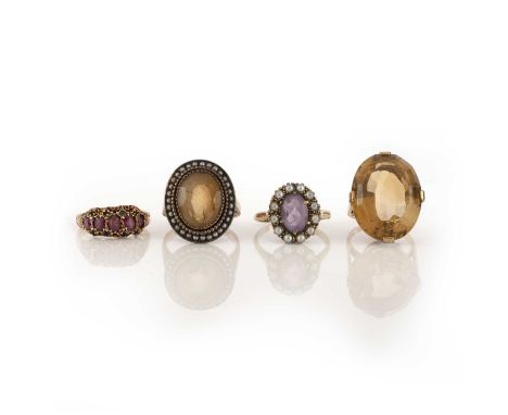 A group of four rings, comprising: a gold ring claw-set with an oval step-cut citrine, size J, stamped 9CT; a citrine and see