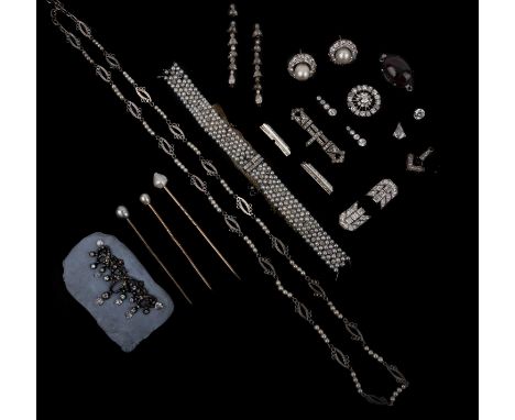 A collection of jewellery components including an unset circular cut diamond, a mounted kite-shaped diamond, partly laid out 