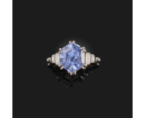 A sapphire and diamond ring, the step-cut sapphire weighing approximately 7.00cts, with diamond-set shoulders in white gold, 