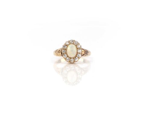 An opal and diamond ring, of cluster design, set with a cabochon opal within a border of circular-cut diamonds, mounted in go