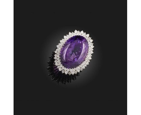 An amethyst and diamond ring, the oval amethyst is set within surrounds of small round brilliant-cut diamonds in white gold, 