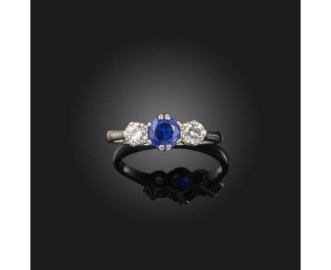 A sapphire and diamond ring, mid 20th century, claw-set with a circular-cut sapphire between brilliant-cut diamonds, mounted 