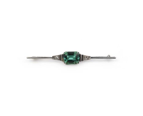 An Art Deco tourmaline and diamond brooch, 1930s, set with a step-cut green tourmaline, to a bar brooch set with single-cut d