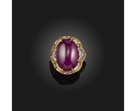 A ruby and diamond ring, claw-set with a cabochon ruby weighing approximately 16.00 carats, to a mount set with brilliant-cut