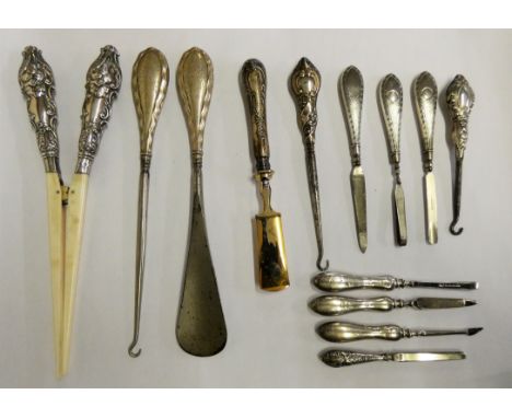 A pair of silver handled glove stretchers Birmingham 1900, three silver handled button hooks and other silver handled impleme