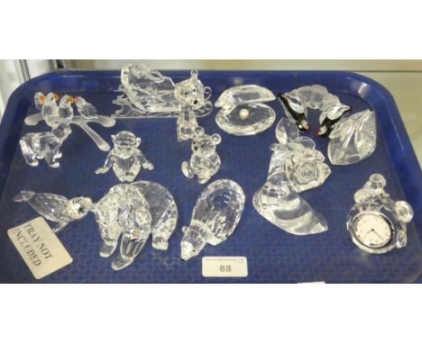 An assortment of sixteen Swarovski figures to include an alarm clock, rose, teddy, monkey, sleigh, parrots on branch, seal, p