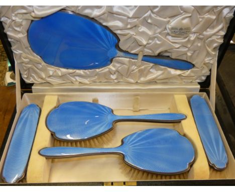 A silver and blue enamel five piece dressing table set, Birmingham 1934, Coronation mark, case