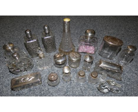 A collection of silver and plated topped glass jars and trinket dishes