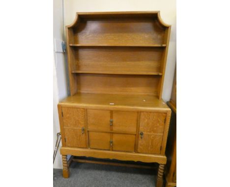 An oak dresser compromising of two shelf units over two drawers and two linen cupboards, 106 x 180cm