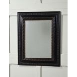AN EBONISED AND SHIVER MOULDED FRAMED WALL MIRROR IN DUTCH 17TH CENTURY STYLE
