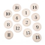 THIRTEEN GLAZED POTTERY NUMBERED WINE/BIN LABELS, MID 19TH CENTURY