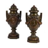 A PAIR OF PATINATED PLASTER MODELS OF URNS