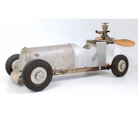 A scratch-built tether style racing car, fitted with miniature petrol engine, with air-screw attachment, and four matching ru
