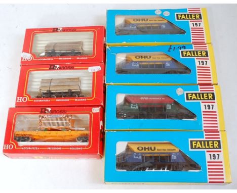 Seven HO wagons; Rivarossi 2090 flat car with circus cage; 2 x 2349 log buggy car, 4 x Faller Ref 197 hopper wagons (one unbo
