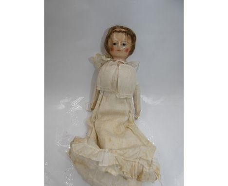 A 19th Century English wooden doll, with inset dark eyes, painted dotted eyelashes and eyebrows, red painted mouth and rosy c