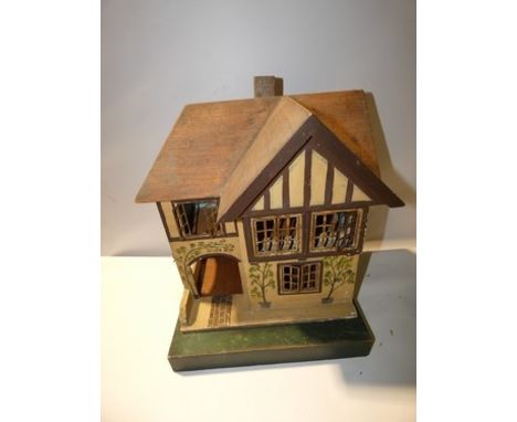 An Early Lines wooden dolls house with 2 levels, with 4 metal shutter windows, painted floral decoration to front and green p