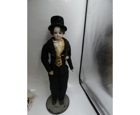 A pressed bisque 1870's fashion doll with swivel head, fixed blue eyes, brown feathered brows, closed mouth, pierced ears, da