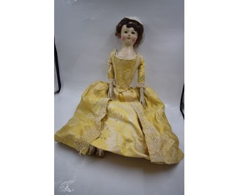 A very rare English George II wooden doll, circa 1740, with carved, turned and painted head and torso with inset dark enamel 